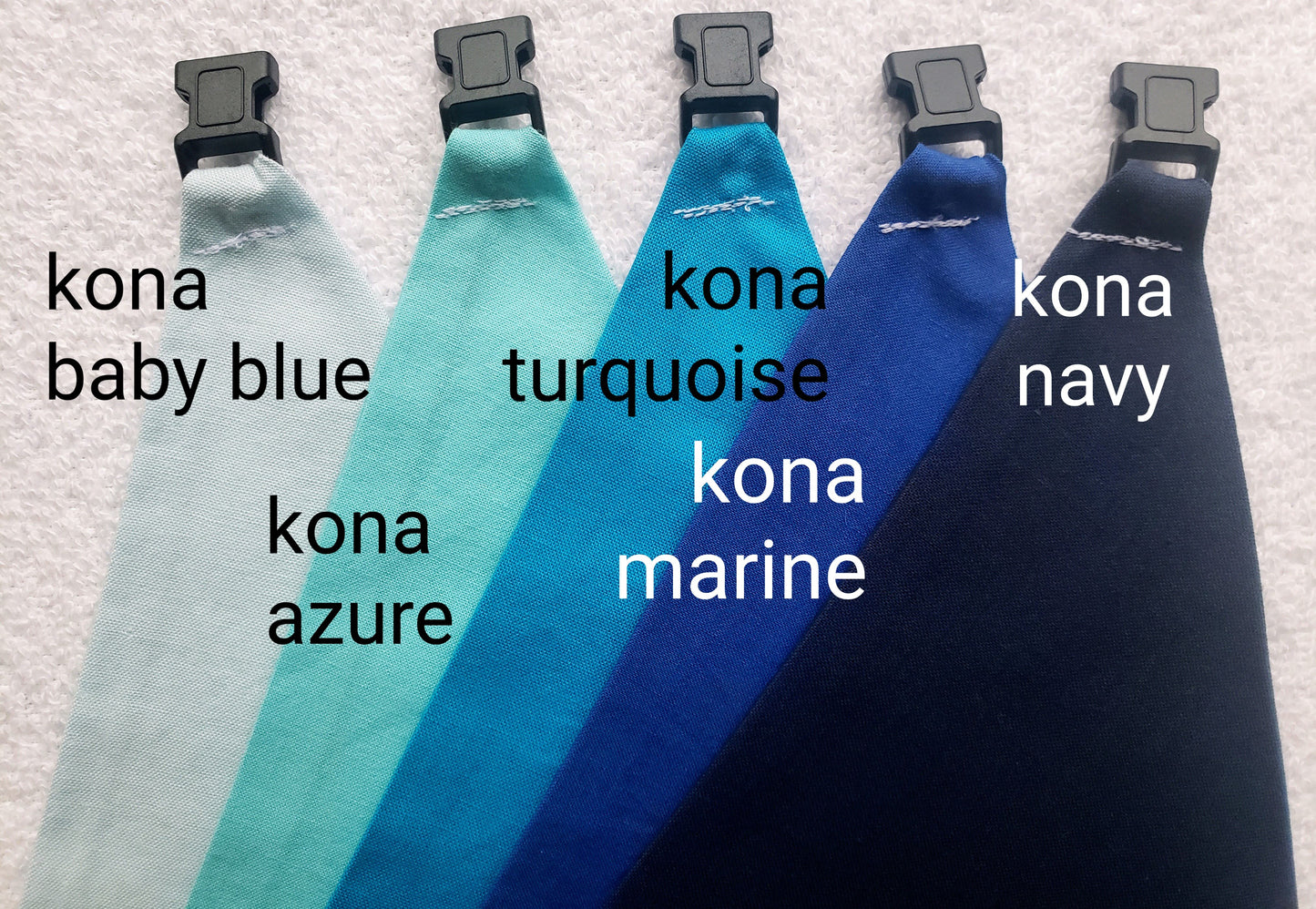 a group of different colored ties with names on them